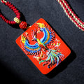 Cinnabar Fire Phoenix Thangka Pendant with colorful phoenix design and red cord, symbolizing rebirth and good luck.