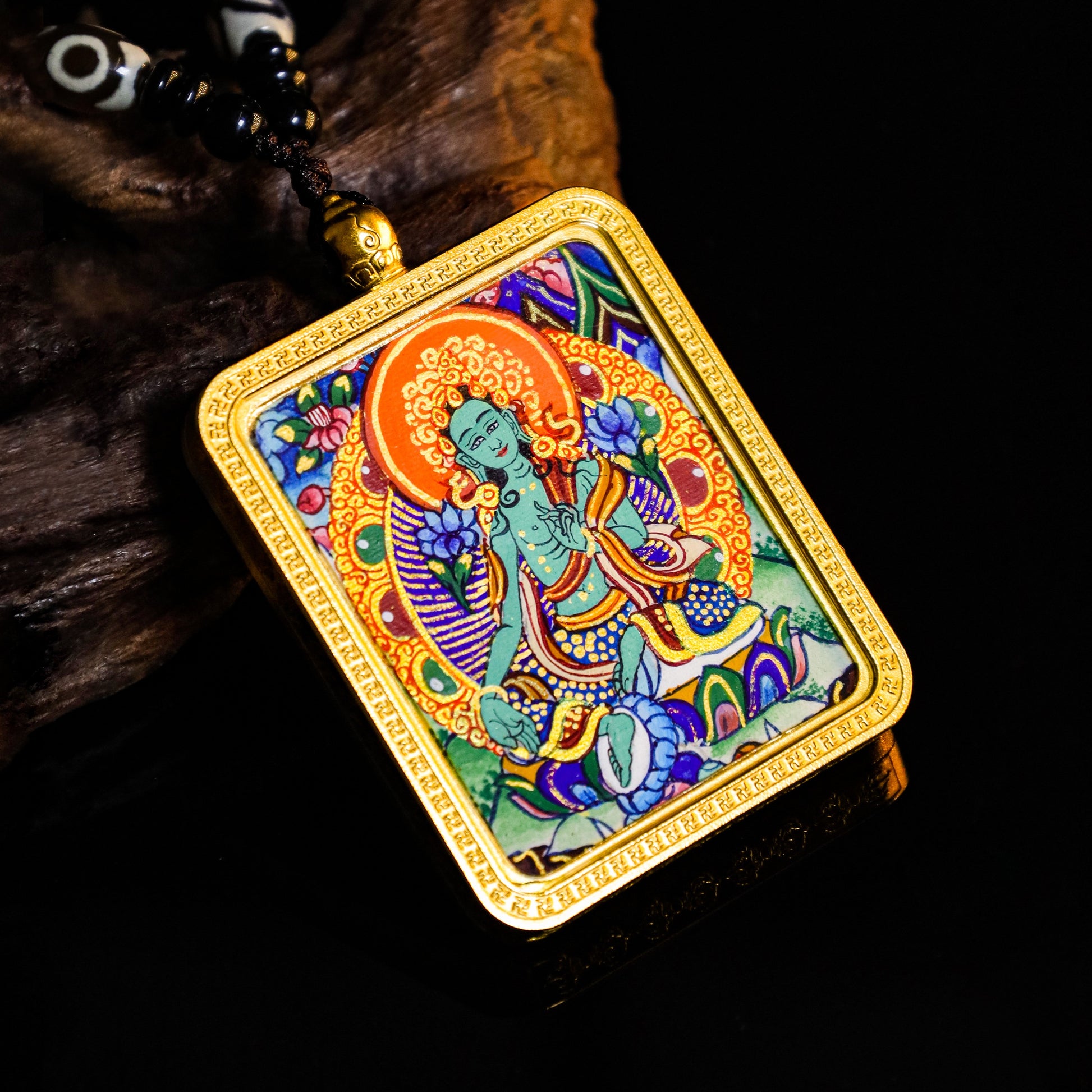 24K Gold hand-painted Green Tara Thangka pendant showcasing intricate artistry and vibrant colors, symbolizing compassion.