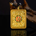 24K gold hand-painted Green Tara Thangka pendant showcasing intricate design and craftsmanship on a wooden background.