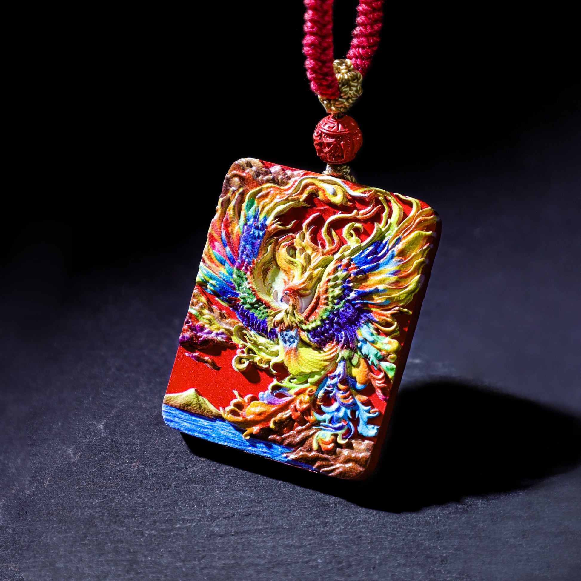 Cinnabar Fire Phoenix Thangka Pendant showcasing vibrant colors and intricate details, symbolizing rebirth and good luck.